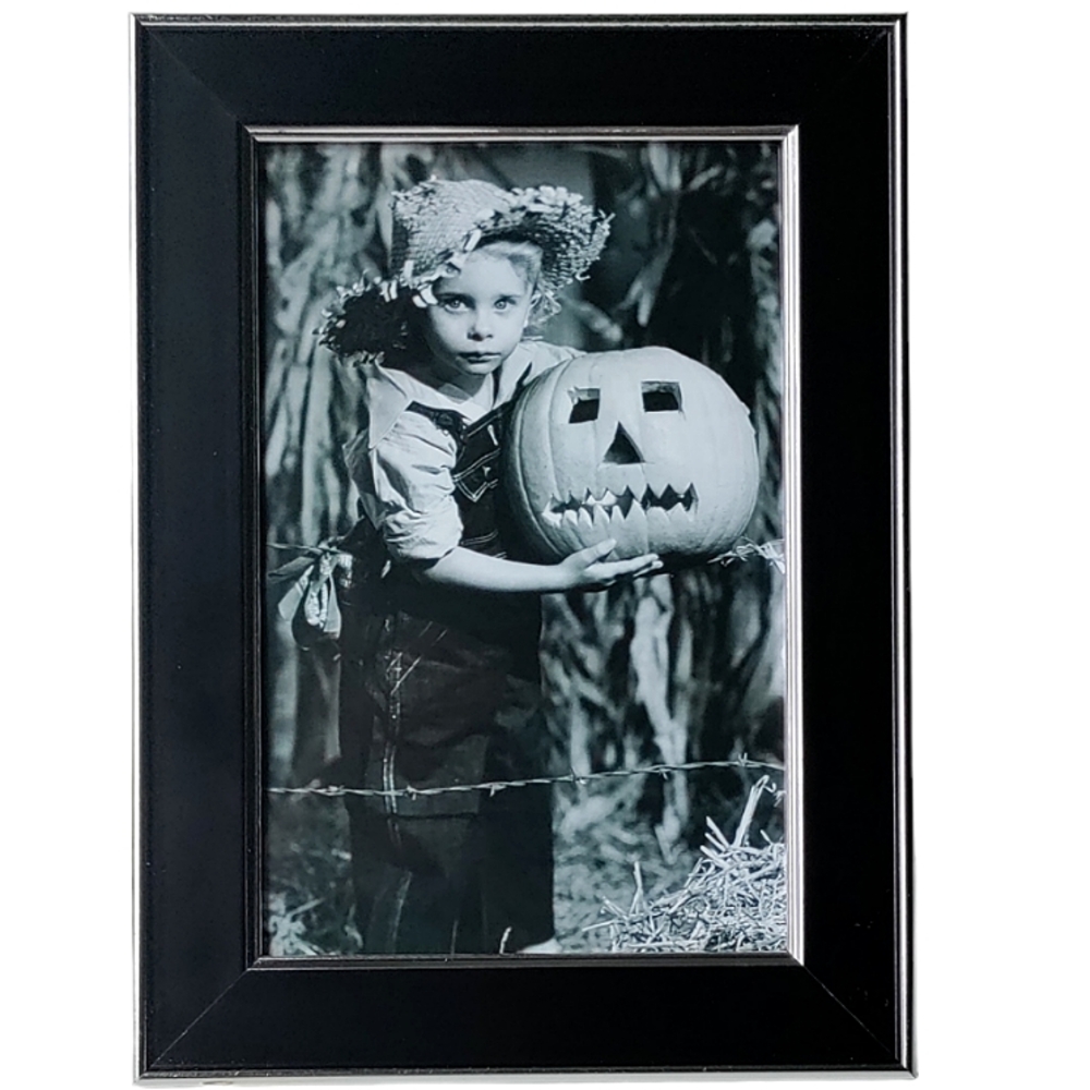 Vintage little girl with straw hat holding carved pumpkin Halloween fall autumn
